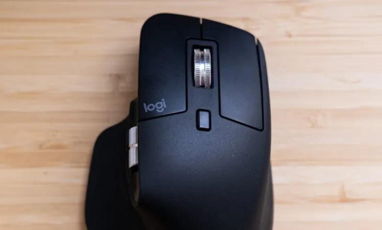 Close-up of a black Logitech MX Master 3S mouse with a silver scroll wheel.