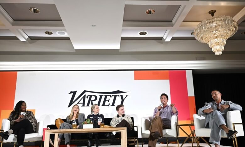 Five people sit on a stage during a panel discussion with the Variety logo behind them.