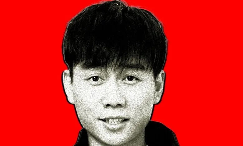 Close-up portrait of a young Asian man with dark hair against a vibrant red background.