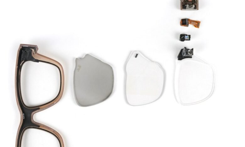 Disassembled smart glasses showing frame, lenses, and electronic components.