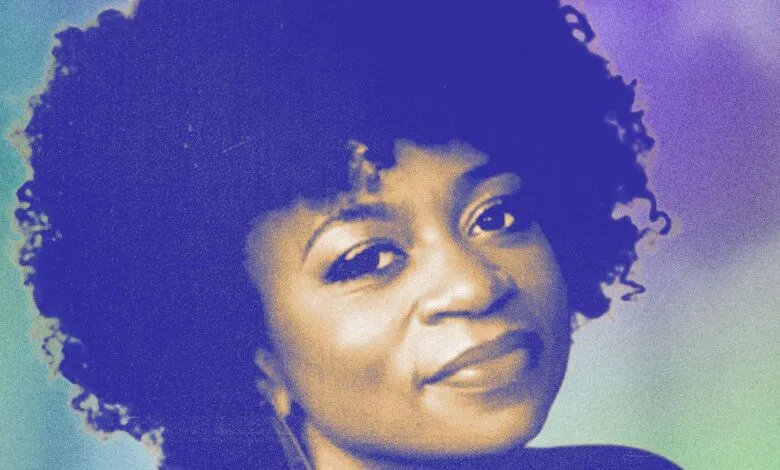 Close-up portrait of a Black woman with a large afro, looking slightly to the side.