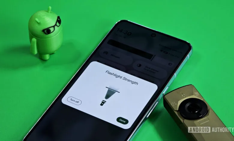 Smartphone displaying Android flashlight strength control UI with an Android mascot and a small flashlight.