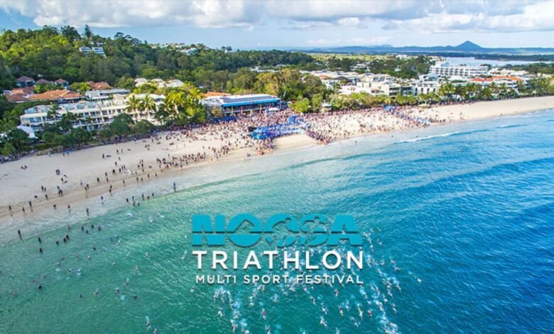 Aerial view of the Noosa Triathlon swim start with many participants in the ocean.