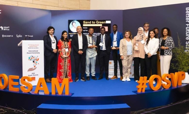 Group of award recipients and organizers posing on stage at an international award ceremony.