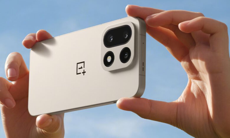 Hands holding a light beige OnePlus smartphone, showcasing its camera module against a blue sky.