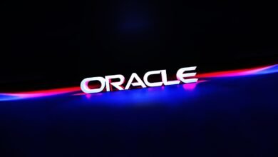 The Oracle logo in white 3D letters with neon red and blue lighting.