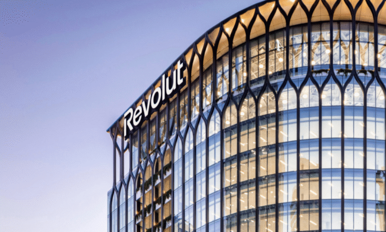Close-up of the Revolut office building exterior with its distinctive arched windows and illuminated logo.