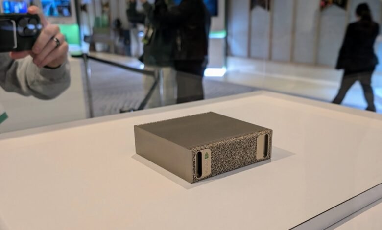 NVIDIA GPU server module on display with blurred background of event attendees.