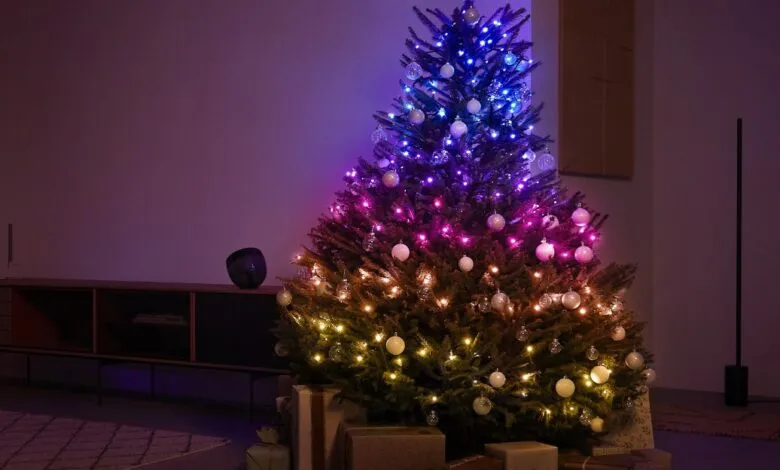 A decorated Christmas tree with colorful smart lights and ornaments.