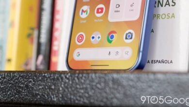 Close-up of a blue smartphone displaying the Google search bar and app icons.
