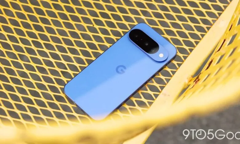 Blue Google Pixel smartphone with a distinctive camera bar resting on a yellow metal grate.
