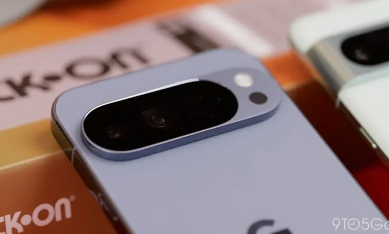 Close-up of the rear camera module of a light purple smartphone, with another white smartphone visible.