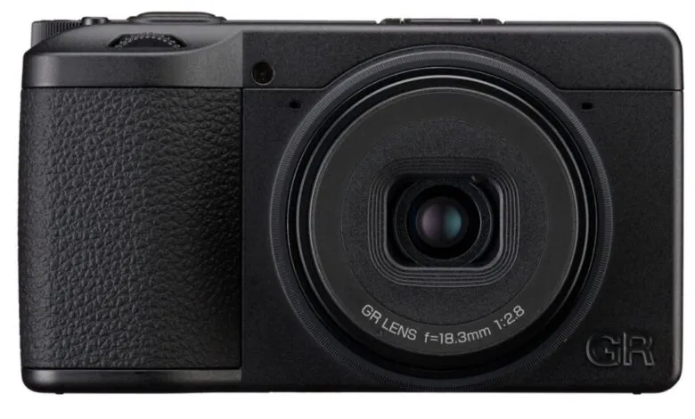 Close-up front view of a black Ricoh GR IV monochrome digital camera.