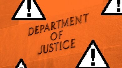 Department of Justice building facade with pixelated warning signs