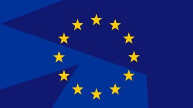 The flag of the European Union with its circle of yellow stars on a blue background.