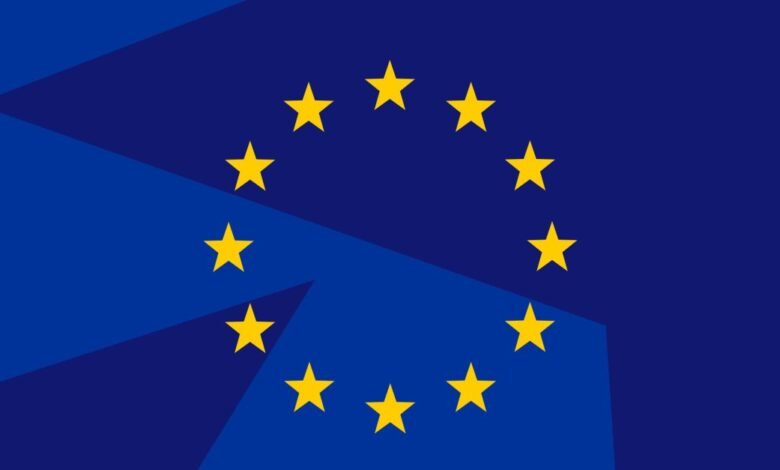 The flag of the European Union with its circle of yellow stars on a blue background.