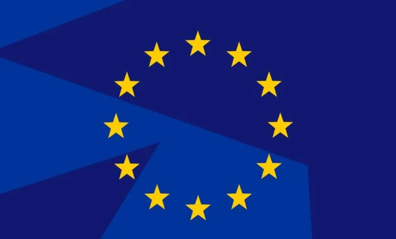 The flag of the European Union with its circle of yellow stars on a blue background.