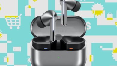 Close-up of sleek, silver wireless earbuds in an open charging case against a teal and white graphic background with shopping icons.