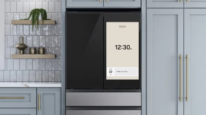 Smart refrigerator with a large touchscreen displaying the time and calendar.