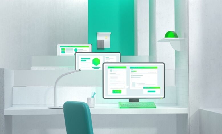 Modern office desk with multiple screens displaying data dashboards and forms.