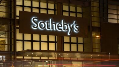 Sotheby's illuminated sign on a modern building at night