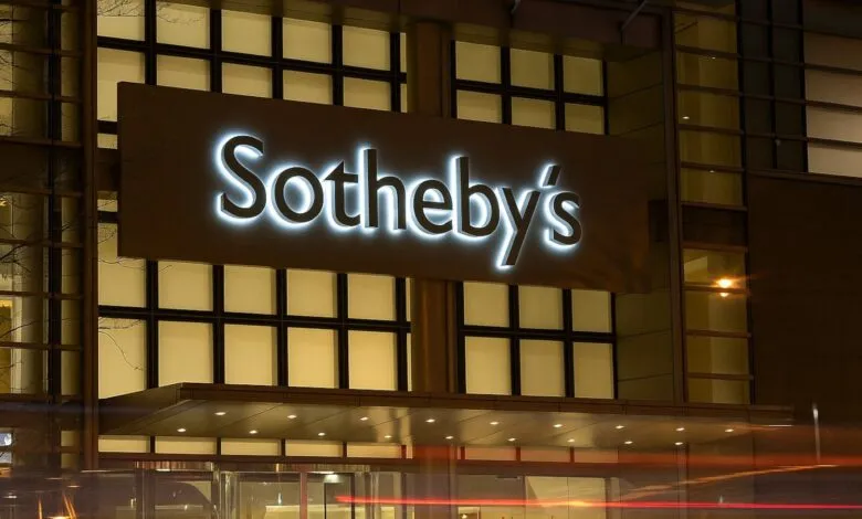Sotheby's illuminated sign on a modern building at night