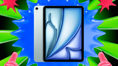 Silver tablet device with a vibrant, abstract digital art display, surrounded by colorful, spiky abstract shapes.