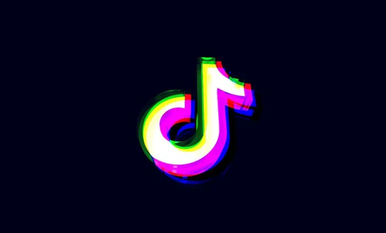 The TikTok logo with a glitch effect, featuring vibrant red, green, and blue chromatic aberration.