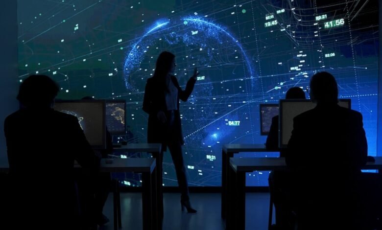 Silhouettes of people in a dark room looking at a large screen displaying a glowing blue globe with data.
