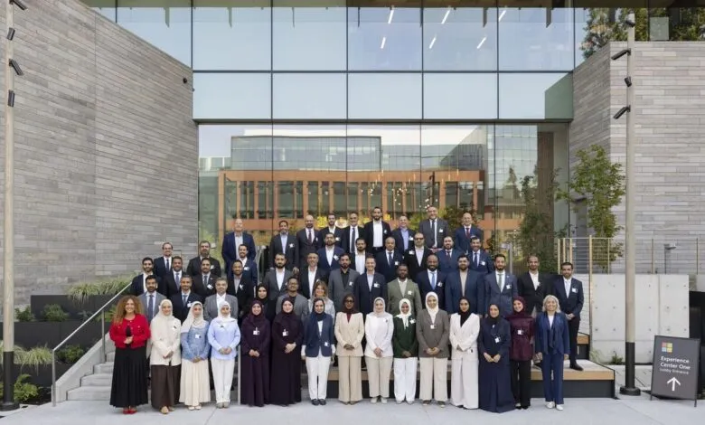 Group photo of UAE Chief AI Officers posing for a formal picture outside a modern building.