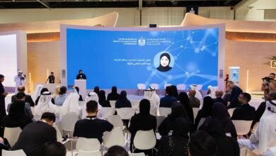 Speaker at podium addressing an audience in front of a large screen displaying the UAE Ministry of Climate Change and Environment logo.