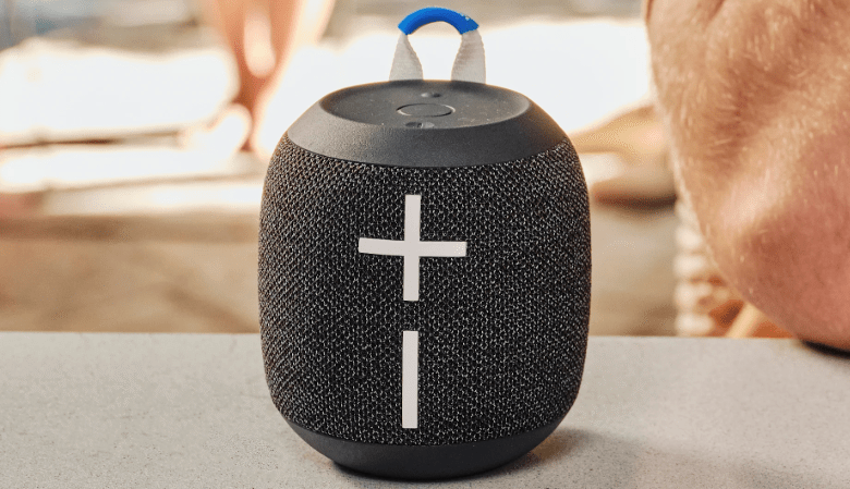 Close-up of a black Ultimate Ears Wonderboom portable Bluetooth speaker with a blue loop.