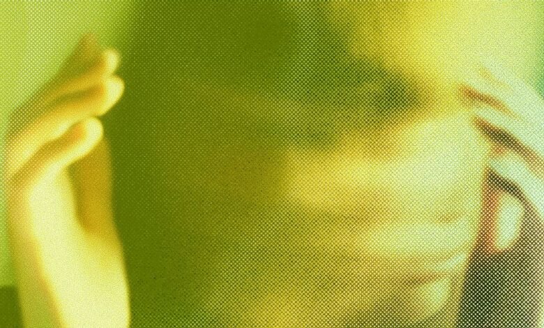 Close-up of a person's face with hands covering their eyes, rendered in a green and yellow halftone effect.
