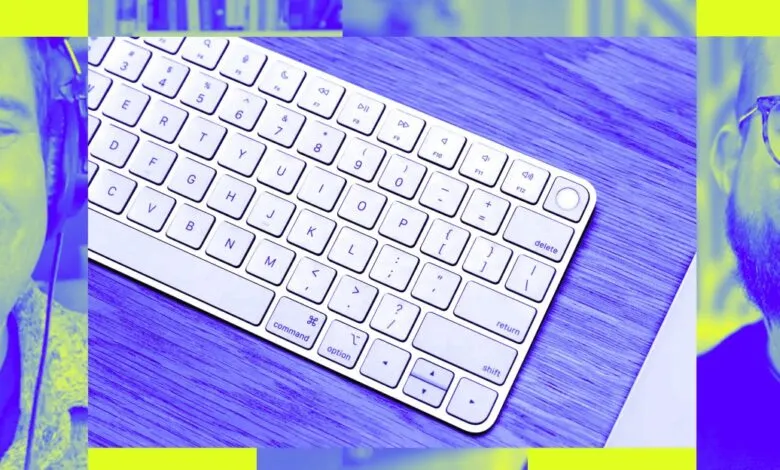 Close-up of a white keyboard with two men's faces on either side, rendered in blue and yellow.