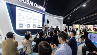 Speaker presenting Dubai Chamber Digital initiatives to an audience at an event.
