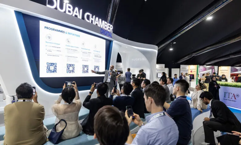 Speaker presenting Dubai Chamber Digital initiatives to an audience at an event.