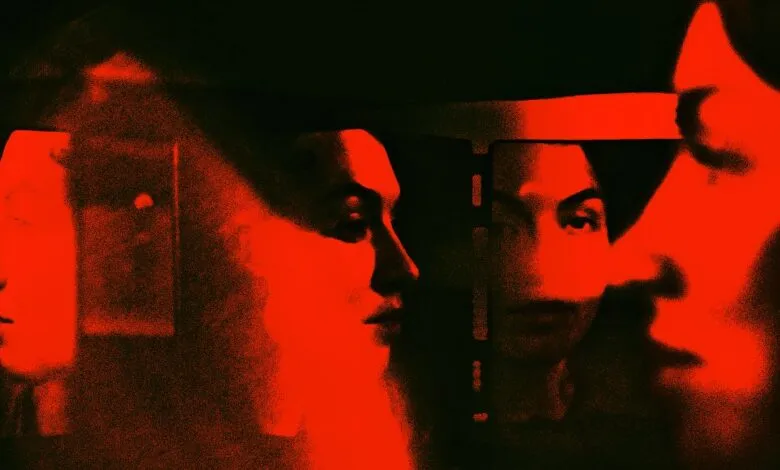 Abstract red and black image of multiple faces in profile, suggesting fragmented identity or perception.