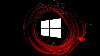 The Windows logo is displayed in white against a black background, surrounded by swirling red light streaks.