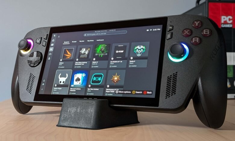 Close-up of a handheld gaming PC displaying a game library with colorful icons.