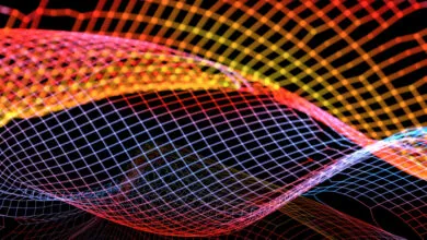 Abstract glowing grid with flowing lines in red, orange, yellow, and blue on black background.