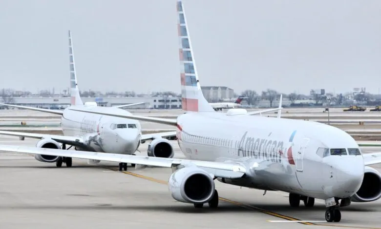 Two American Airlines airplanes on the tarmac at an airport.