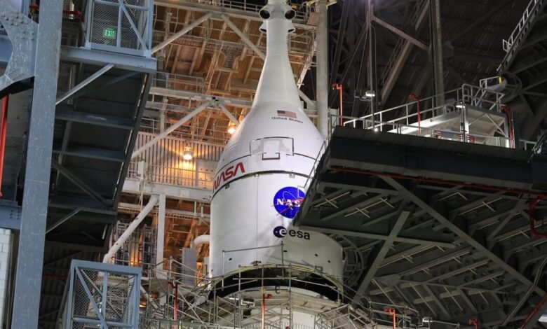 NASA rocket in a launch tower, with ESA and United States markings.