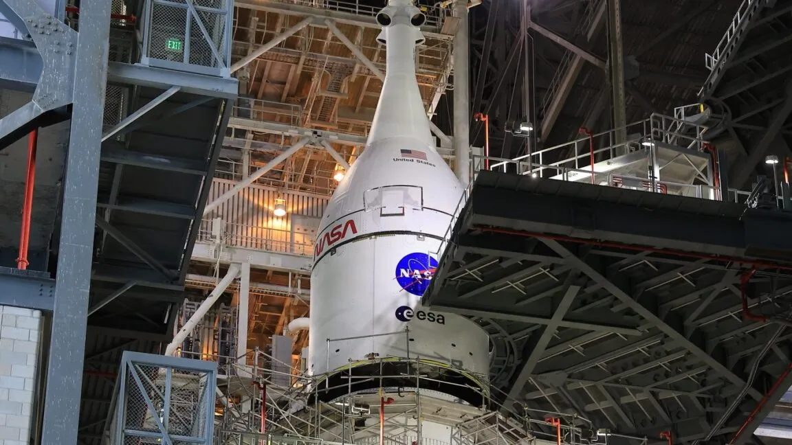 NASA rocket in a launch tower, with ESA and United States markings.