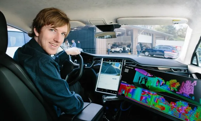 Austin Russell, CEO and co-founder of Luminar, sits in the driver's seat of a car with advanced lidar display.