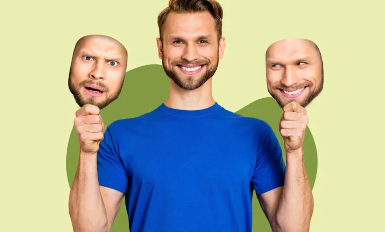 Man holding masks with different facial expressions, representing changing emotions.