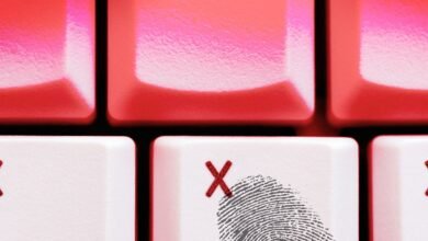 Close-up of white keyboard keys with red X marks and a fingerprint graphic.
