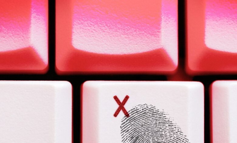 Close-up of white keyboard keys with red X marks and a fingerprint graphic.