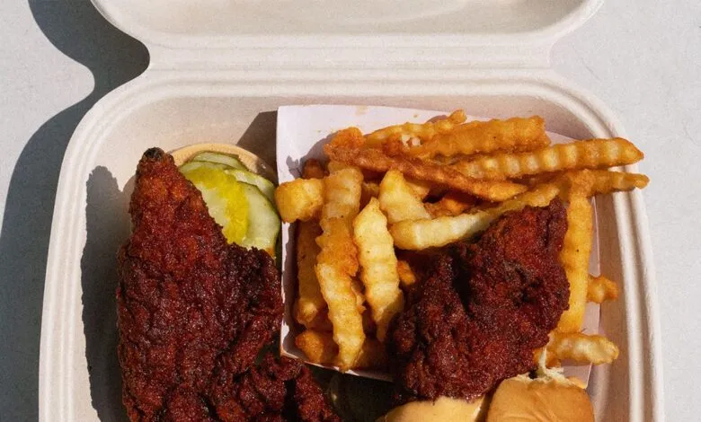 Crispy fried chicken tenders and crinkle-cut fries in a takeout container.