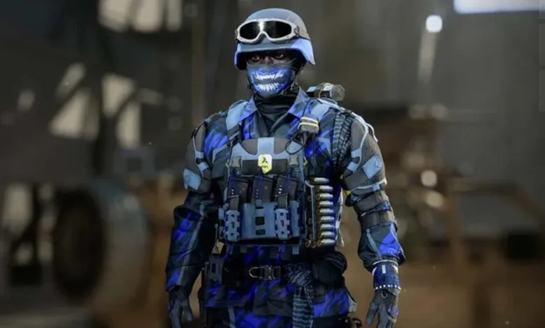 Soldier in blue and black camouflage with a skull mask and tactical gear.