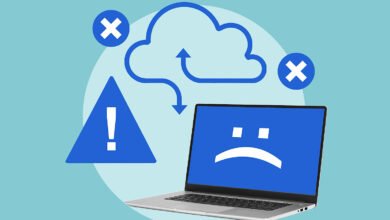 Laptop displaying a sad face icon, with error symbols and a cloud graphic indicating a system failure.